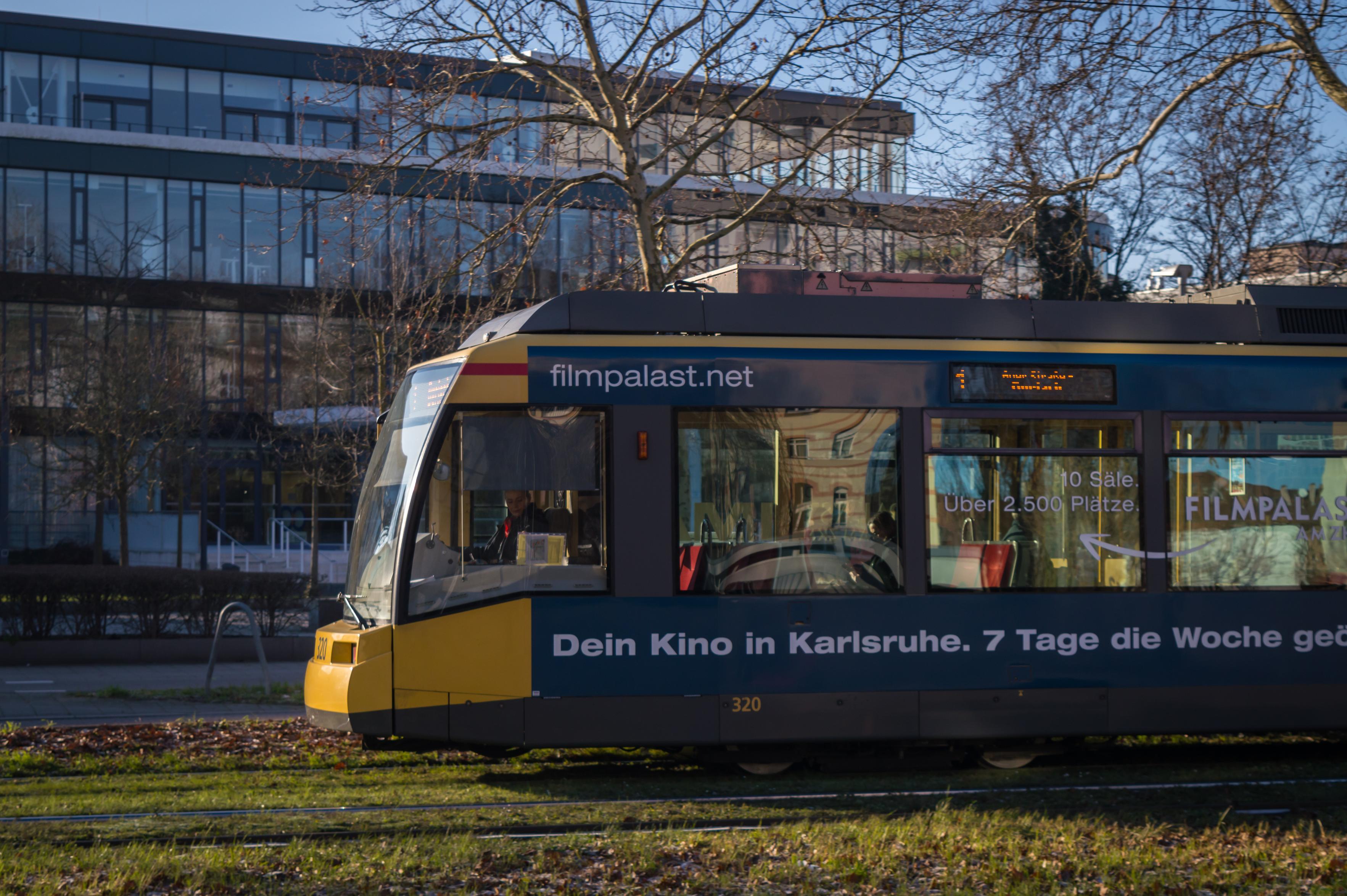 A tram passing by, the front part of it is photographed